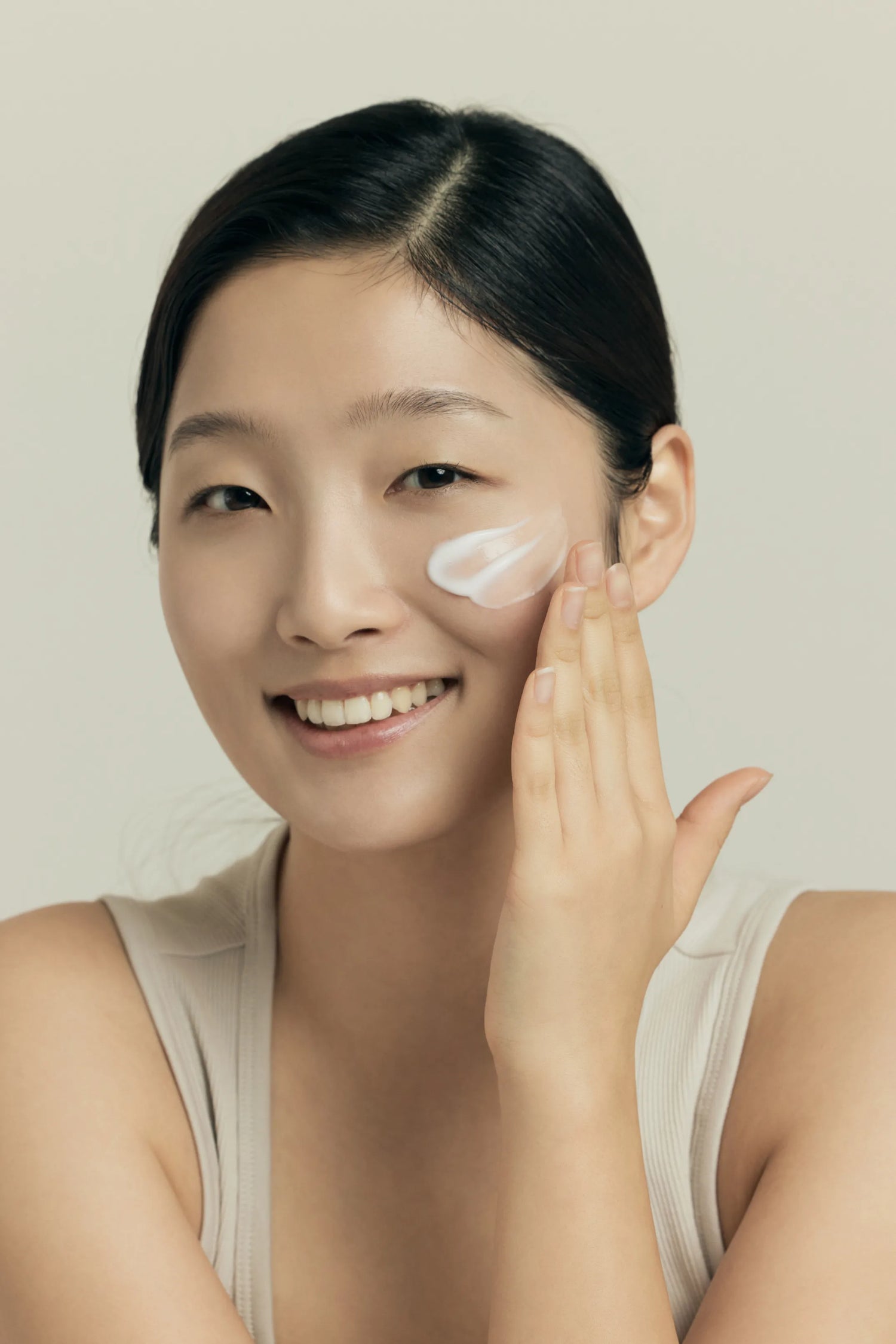 Woman applying Dr. SENSi Barrier Cream to her face